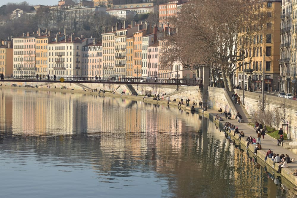 Les façades colorées des quais de Saône, à Lyon, et des promeneurs au soleil